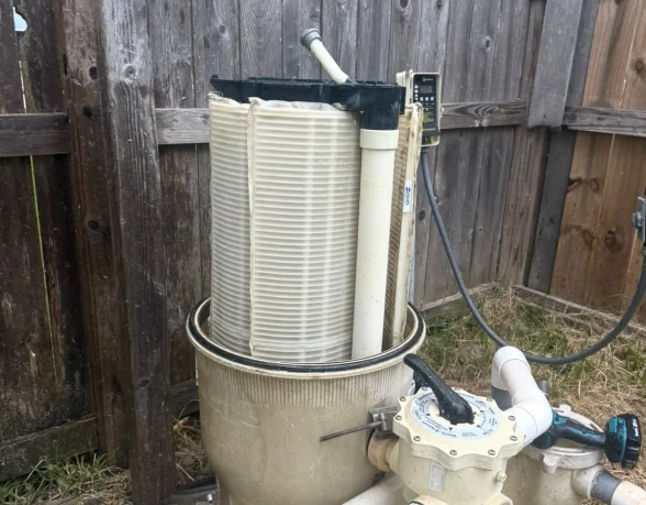 Clean pool filter cartridges after service